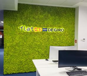Green moss wall with backlit logo
