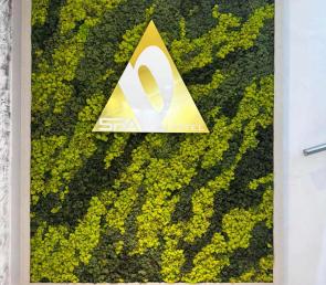 Green wall with the logo of Hotel Persenk, town of Devin